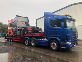 blue scania artic lowloader with unit and tipper