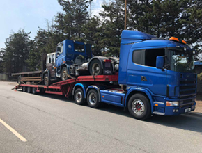 blue scania artic lowloader with unit and flatbed