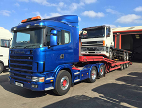blue scania artic lowloader with white daf flatbed rigid