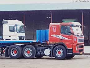 red volvo fm12 from distance